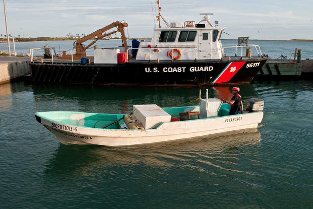 A crewmember of Coast Guard Station South Padre Island pilots a captured lancha
