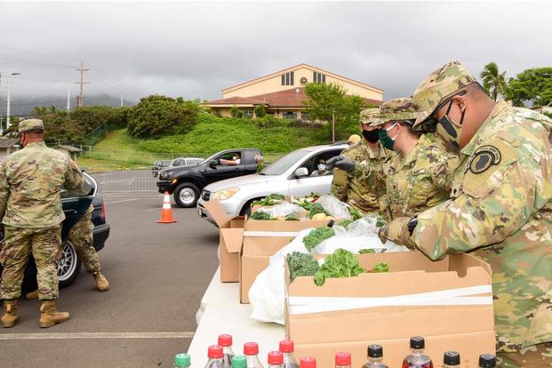 Members of the Hawaii National Guard distribute groceries.