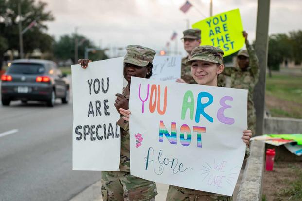 Airmen hold suicide prevention n messages of support.