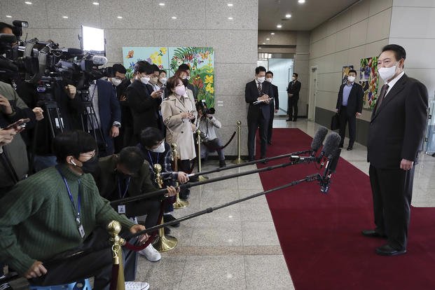 South Korean President Yoon Suk Yeol, right, speaks to reporters