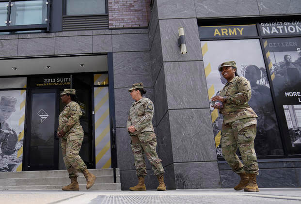 Army National Guard members stand outside the Army National Guard office during training