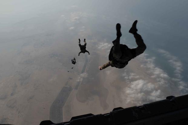 Troops jump from a C-130 during a training event over Bahrain.