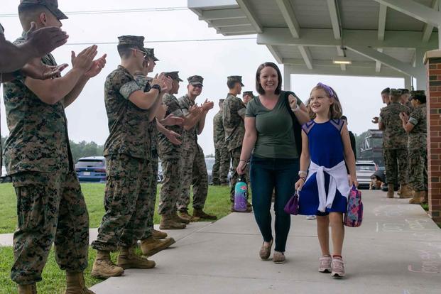 U.S. Marines greet students at Marine Corps Base Quantico.
