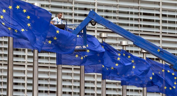 EU flags in front of EU headquarters in Brussels.