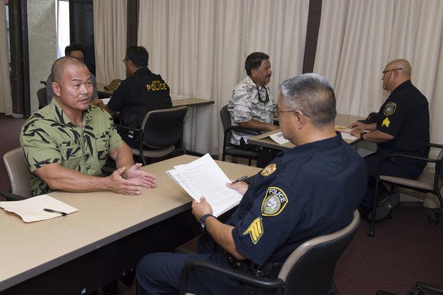 Spencer Kam, of Pearl City, Hawaii, answers questions during an interview for a security guard position at a job fair held at the Federal Fire Department on Joint Base Pearl Harbor-Hickam (JBPHH).