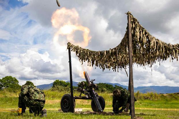 A Colombian Army mortar team launches rounds.