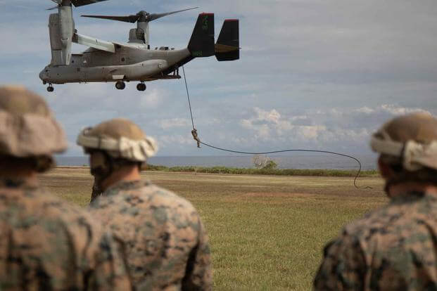 Marines conduct fast-rope training out of an Osprey.
