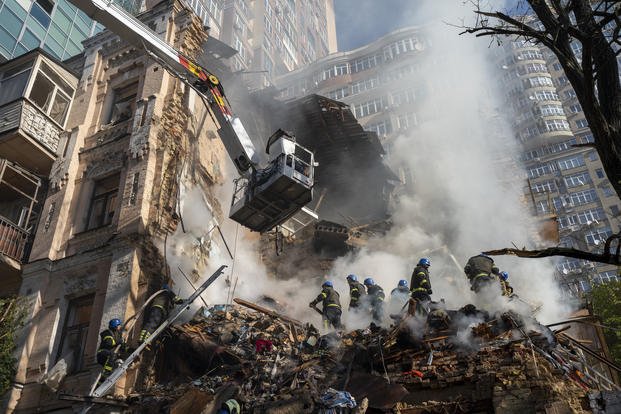 Firefighters work after a drone attack on buildings in Kyiv, Ukraine.