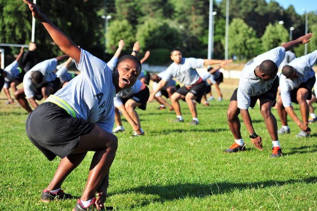 Staff Sgt. Juna C. Cyriaque, a personnel noncommissioned officer assigned to the 21st Theater Sustainment Command’s Special Troops Battalion, leads her class in performing “the windmill” during physical readiness training.