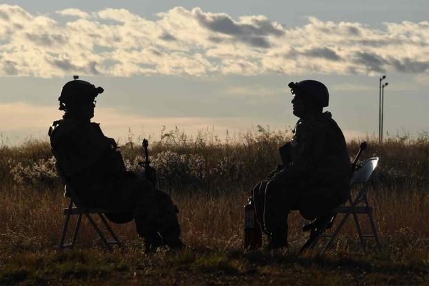 Two service members talking at the East Range Training Grounds, Fort Huachuca.