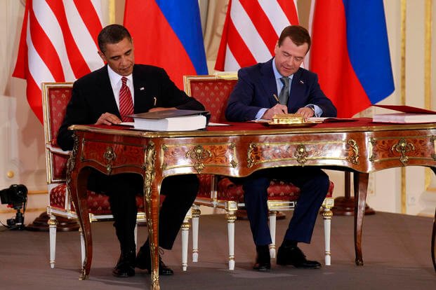 President Barack Obama, left, and Russian President Dmitry Medvedev sign the New START treaty
