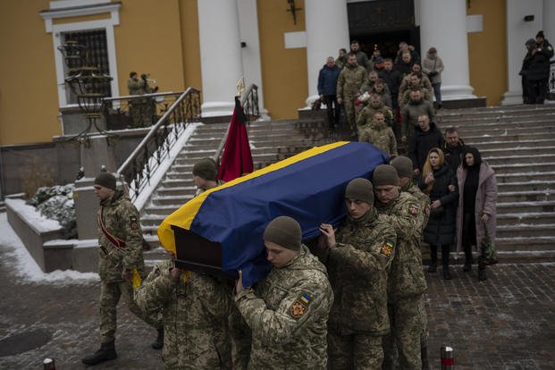 Soldiers carry the coffin of Eduard Strauss, a Ukrainian serviceman who died in combat
