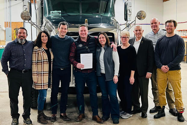 Chris Dambach (holding the piece of paper) founded his company, Industry Standard USA, in 2010 -- three years before he completed the Entrepreneurship Bootcamp for Veterans. 