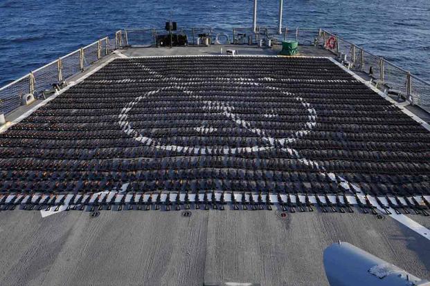 AK-47 assault rifles sit on the flight deck of the USS The Sullivans.