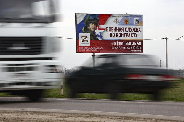 A billboard advertising "Contract military service" beside a highway outside Krasnodar, Russia.