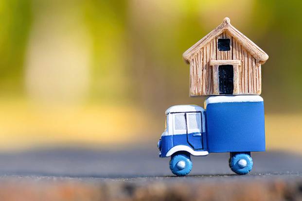 A tiny home moves on a tiny truck