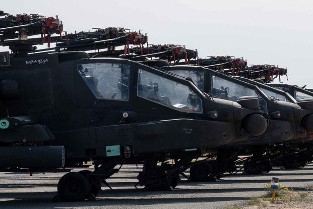 U.S. Army AH-64 Apaches sit on the flight line at Ali Al Salem Air Base, Kuwait.