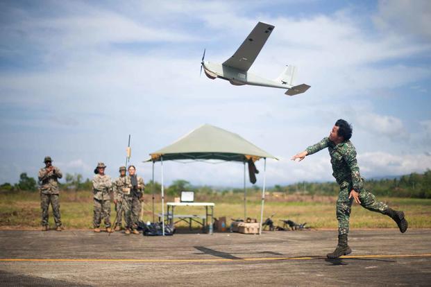 A Philippine Marine launches an unmanned aircraft system.