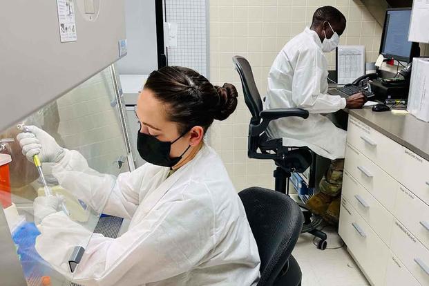 U.S. Army medical personnel prepare a sample for COVID-19 testing