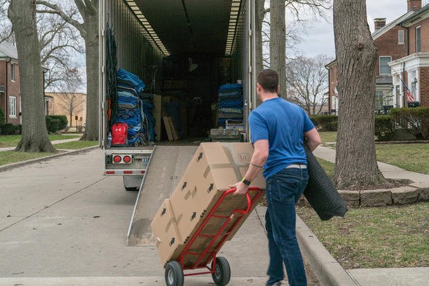 A moving contractor loads a moving truck with a service member's household goods during the permanent change of station peak-season at Scott Air Force Base, Ill.