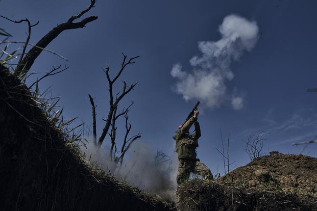 Ukrainian soldier fires a grenade launcher on the frontline in Bakhmut, Donetsk region, Ukraine