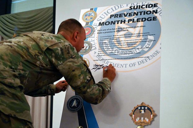U.S. Army Col. Mitchell Wisniewski III, Joint Base McGuire-Dix-Lakehurst (N.J.) deputy commander and Army Support Activity commander, signs the Suicide Prevention month declaration inside the dining hall of Tommy B’s lounge on the base.