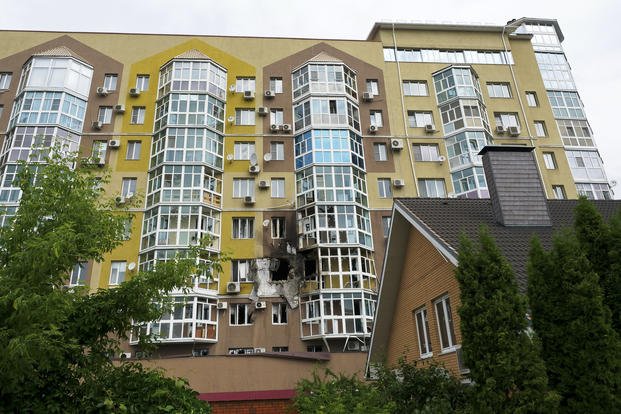 Broken windows and traces of fire are seen after a drone fell at a residential building in Voronezh, Russia