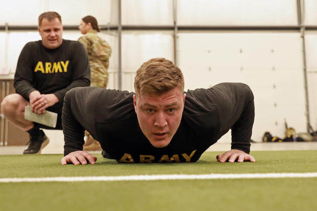 Sgt. Timothy Coggins, a 310th Sustainment Command (Expeditionary) soldier, conducts push-ups at the Army Combat Fitness Test event during the 2023 Best Warrior competition at Camp Atterbury, Ind. 