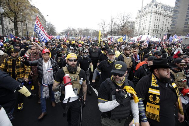 People wearing Proud Boys attire attend a rally at Freedom Plaza in Washington