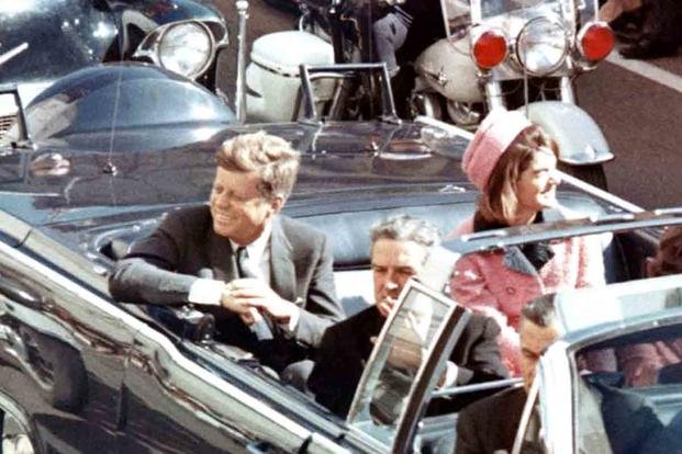 President John F. Kennedy in the limousine in Dallas, Texas, on Main Street, minutes before the assassination. Also in the presidential limousine are Jackie Kennedy, Texas Governor John Connally, and his wife, Nellie.