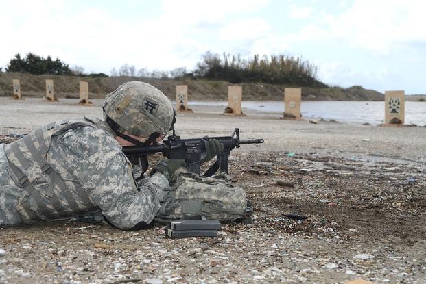 A U.S. Soldier with the 511th Military Police Platoon fires at a 25-meter target during training at Camp Darby in Livorno, Italy, Dec. 17, 2012.
