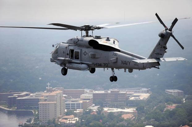 A multi-mission MH-60R Sea Hawk helicopter is en route to home base at Naval Air Station Jacksonville, after an over-water gun exercise.