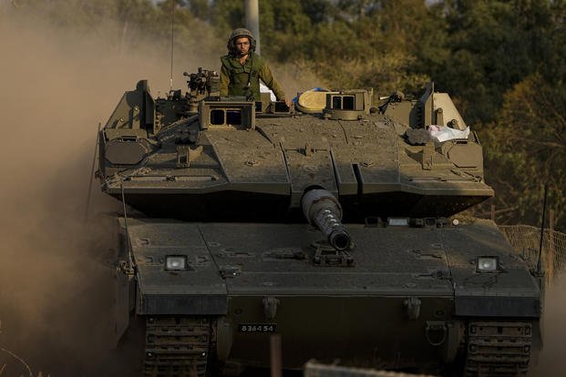 Israeli soldier drive a tank near the border with Lebanon