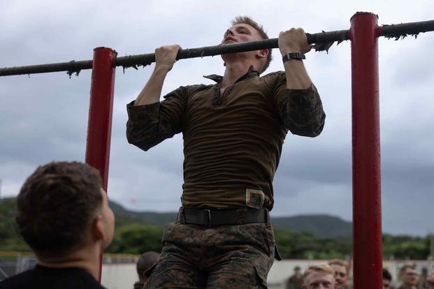 U.S. Marine executes pull ups during a basic jungle skills course