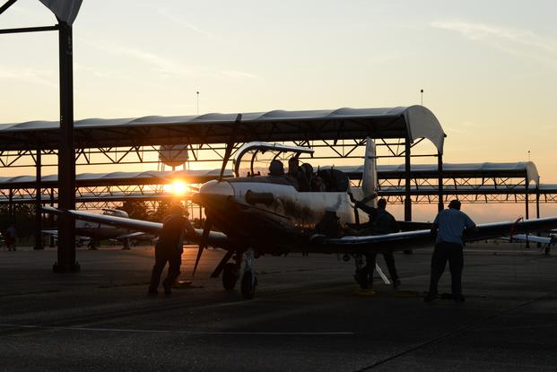 Student pilots sit in a T-6 Texan II while maintainers check the plane before takeoff on Aug. 5, 2019 at Columbus Air Force Base, Miss.