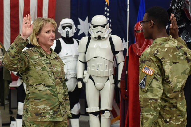 Maj. Gen. DeAnna Burt, Combined Force Space Component Command commander, is sworn into the U.S. Space Force by Second Lt. Wellington Brookins during an International Space Day celebration at Vandenberg Air Force Base, Calif. 
