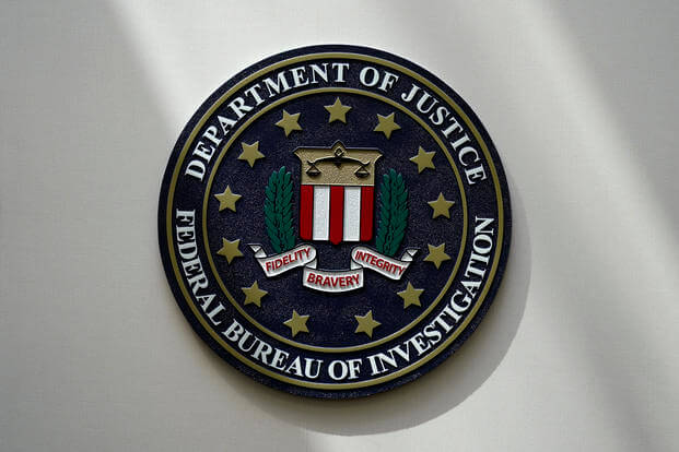 An FBI seal is seen on a wall