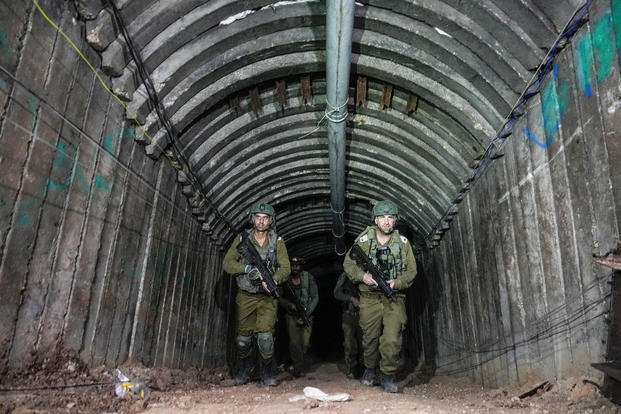 Israeli soldiers are seen in a tunnel.