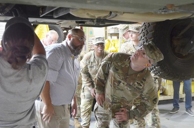 Brig. Gen. Michael B. Lalor, commanding general of the U.S. Army Tank-automotive and Armaments Command takes a closer look at a vehicle during a recent visit to Red River Army Depot while Joshua Braley explains the rework process.