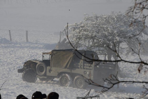 A Dodge WC-63 brings soldiers and equipment for the Battle of the Bulge's combat reenactment during 70th-anniversary commemorations in Bastogne, Belgium.