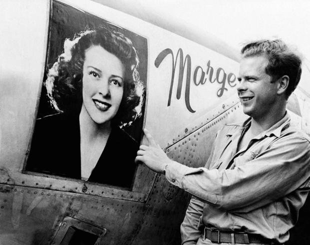Captain Richard J. Bong points to a picture of his girlfriend on his plane.