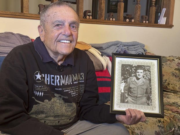 World War II veteran Andy Negra sits in his home