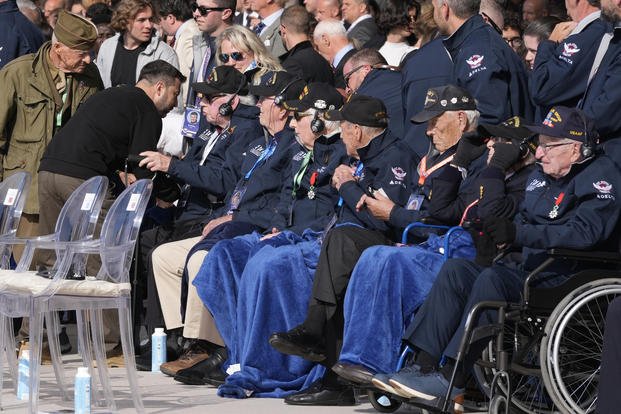 Ukraine's President Volodymyr Zelenskyy, second left, greets World War II veterans