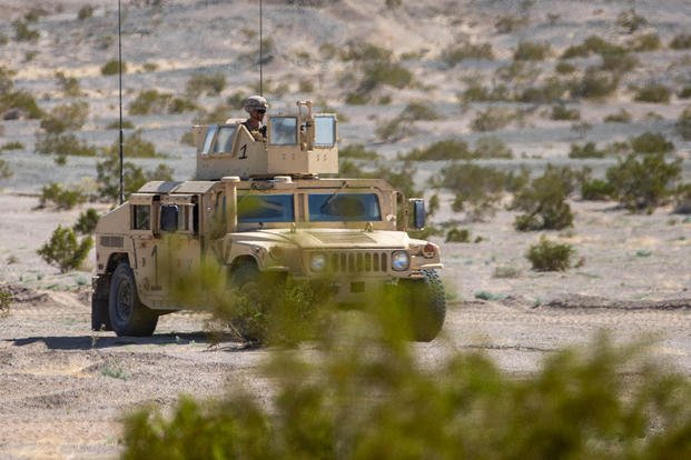 U.S. Marines with Combat Logistics Battalion 2, Combat Logistics Regiment 2, 2nd Marine Logistics Group, operate a Humvee during convoy operations during the Adversary Force Exercise as part of the Service Level Training Exercise 2-24 at Marine Corps Air Ground Combat Center Twentynine Palms, California.