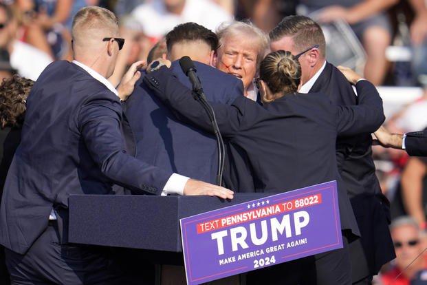 Republican presidential candidate former President Donald Trump is surrounded by U.S. Secret Service at a campaign event in Butler, Pa.