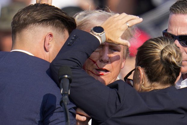 Donald Trump is helped off the stage by Secret Service agents in Butler, Pennsylvania.