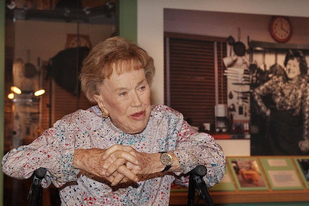 Chef Julia Child talks to reporters at the opening of her kitchen exhibition at the Smithsonian's National Museum of American History in Washington.