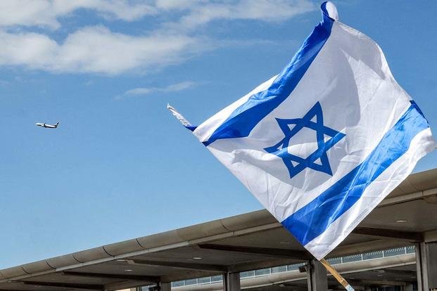 Israeli flag flies during a protest