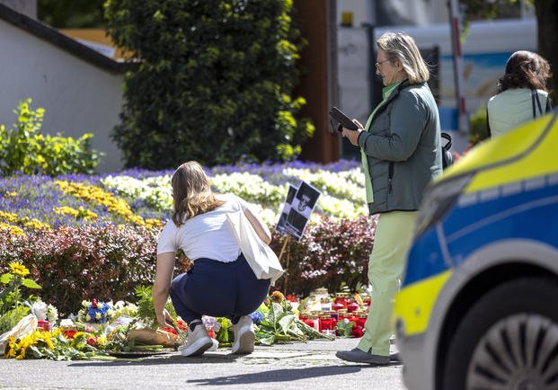 Flowers and candles are placed in Solingen, Germany.