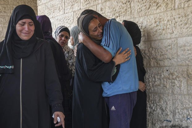 Palestinians grieve at the funeral for more than 15 people.